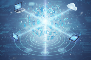 Digital network concept with laptops, tablets, and cloud connected to a central glowing sphere representing data exchange.