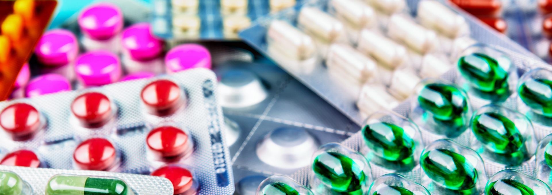 OTC Meds Drug Test + Ambien Various blister packs containing colorful pills and capsules, including red, green, and pink tablets.
