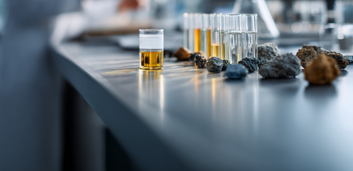 Arsenic Urine Test for Workplace Exposure Monitoring Occupational health laboratory technician analyzing arsenic-containing mineral samples beside a urine specimen collected for workplace arsenic exposure testing.