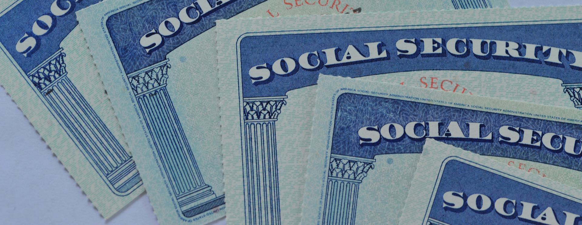 Social Security Number Trace Close-up of multiple Social Security cards overlapping each other.